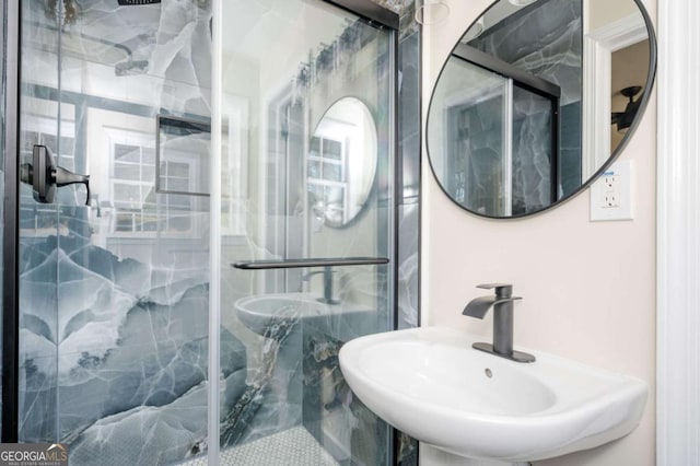 full bathroom with a sink and a marble finish shower