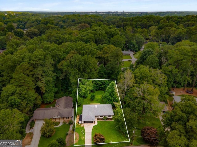 aerial view featuring a wooded view