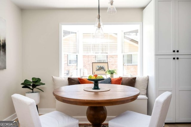 dining room featuring baseboards and breakfast area