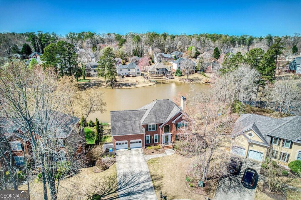 drone / aerial view with a residential view and a water view