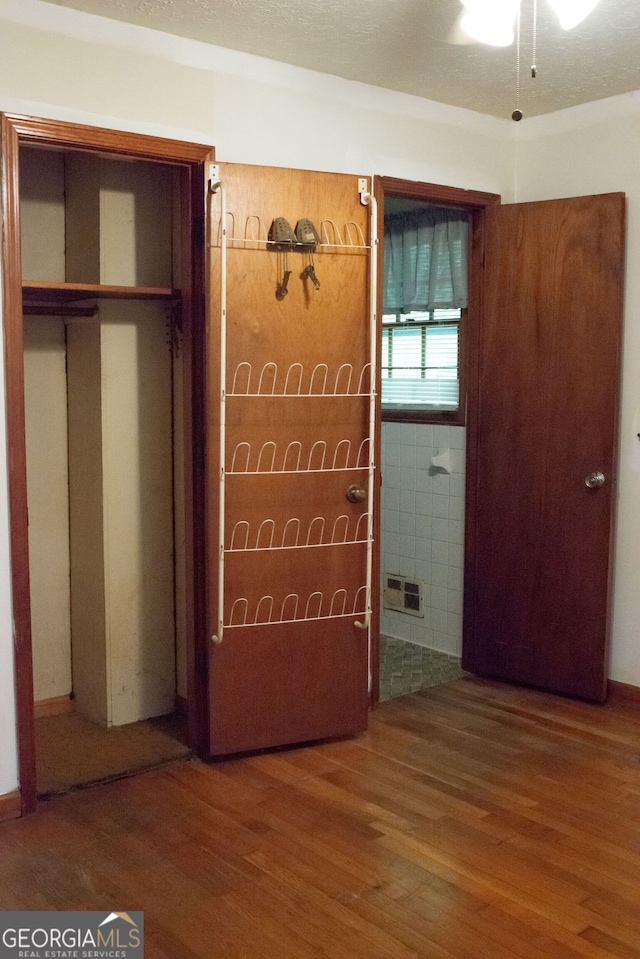 unfurnished bedroom featuring visible vents and wood finished floors