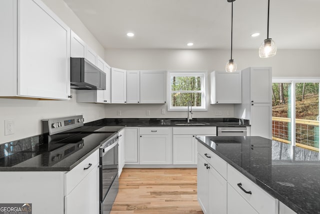 164 Colorado Ln, Clayton, GA 30525 - kitchen featuring light wood finished floors, dark stone countertops, a sink, white cabinetry, and appliances with stainless steel finishes