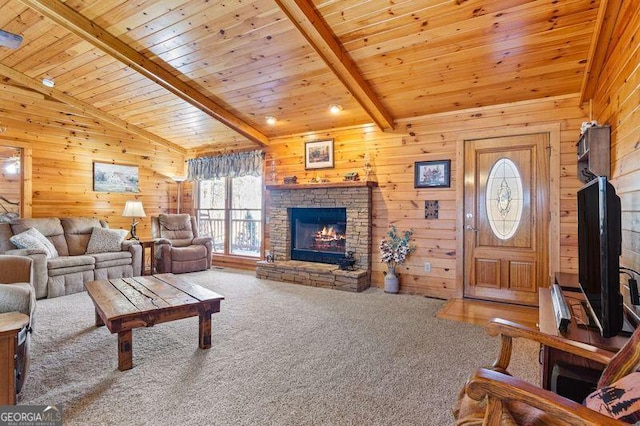 carpeted living room with a stone fireplace, wood ceiling, wooden walls, and beamed ceiling