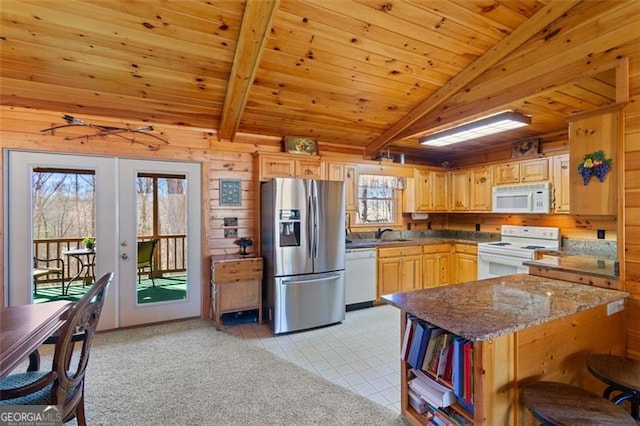 kitchen featuring wood walls, french doors, beamed ceiling, and white appliances