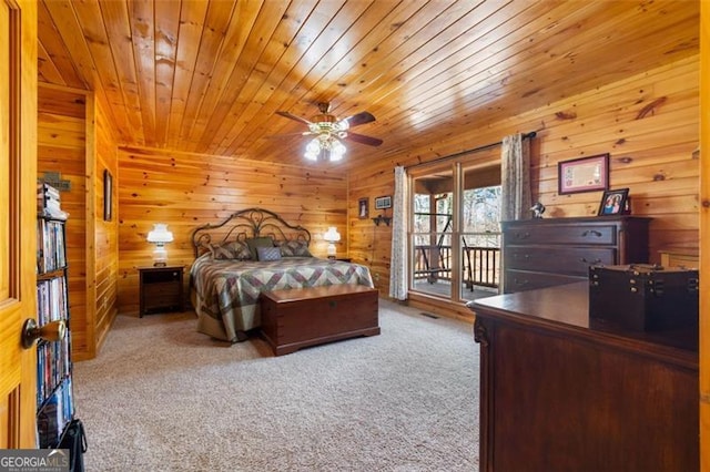 carpeted bedroom with wood ceiling, access to outside, wood walls, and ceiling fan