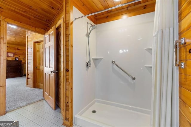 bathroom with wooden ceiling, wood walls, a stall shower, and tile patterned floors