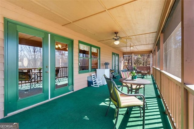 sunroom / solarium with plenty of natural light, french doors, and ceiling fan