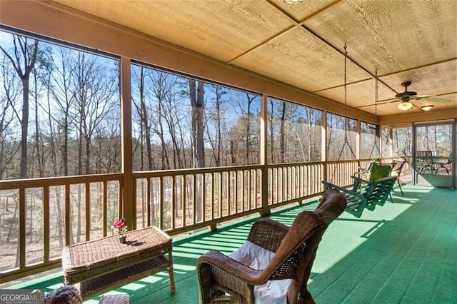 sunroom / solarium featuring ceiling fan