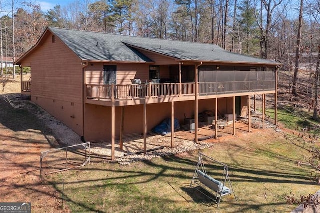 rear view of house with a yard, a deck, a shingled roof, and crawl space