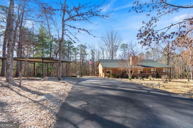 view of front of home featuring aphalt driveway and a carport