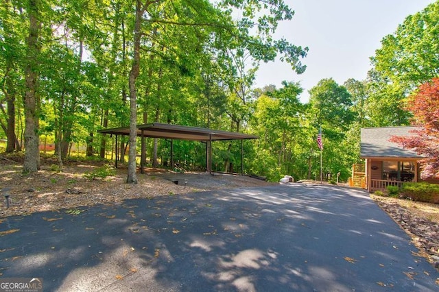 view of home's community with aphalt driveway and a carport
