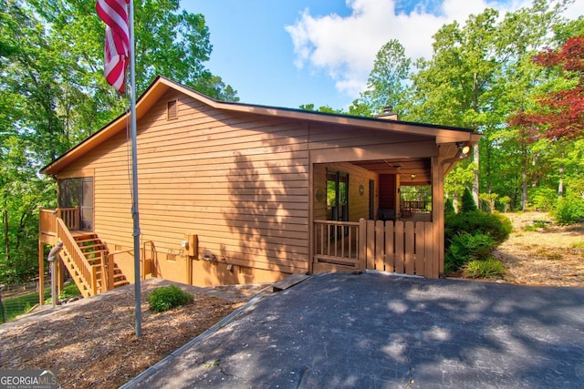 view of side of property featuring a chimney and crawl space