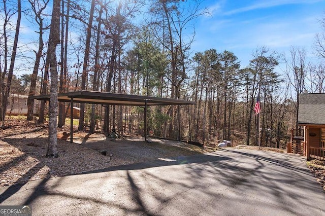 view of yard with driveway and a carport