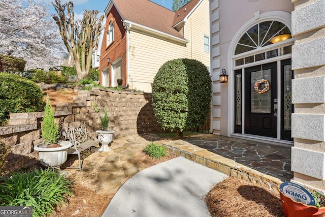 view of exterior entry with a garage