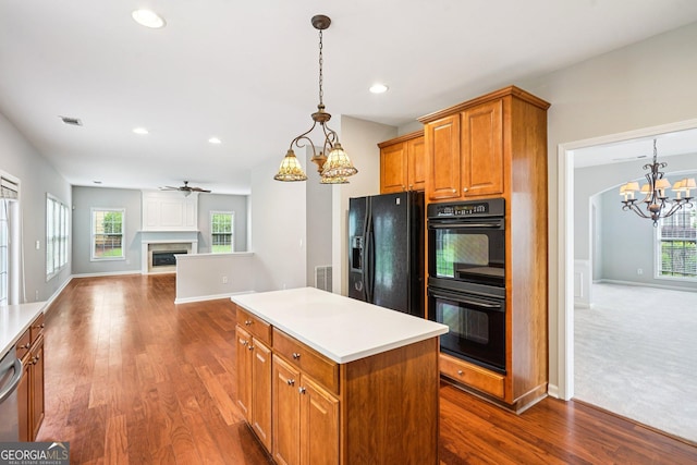 2848 Stockbridge Way, Dacula, GA 30019 - kitchen featuring black appliances, a chandelier, brown cabinetry, dark wood-style flooring, and recessed lighting