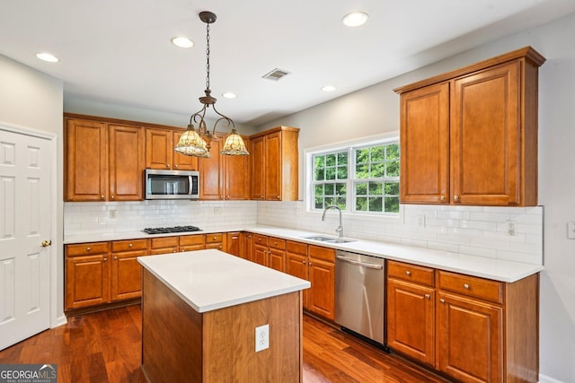 2848 Stockbridge Way, Dacula, GA 30019 - kitchen with stainless steel appliances, a sink, brown cabinetry, dark wood-type flooring, and recessed lighting
