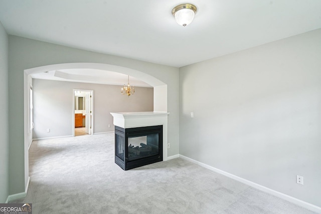 2848 Stockbridge Way, Dacula, GA 30019 - unfurnished living room featuring arched walkways, carpet, and baseboards