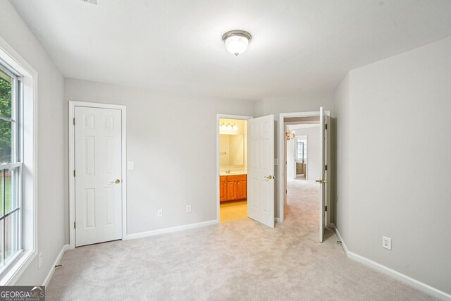 2848 Stockbridge Way, Dacula, GA 30019 - unfurnished bedroom with light carpet, multiple windows, and baseboards