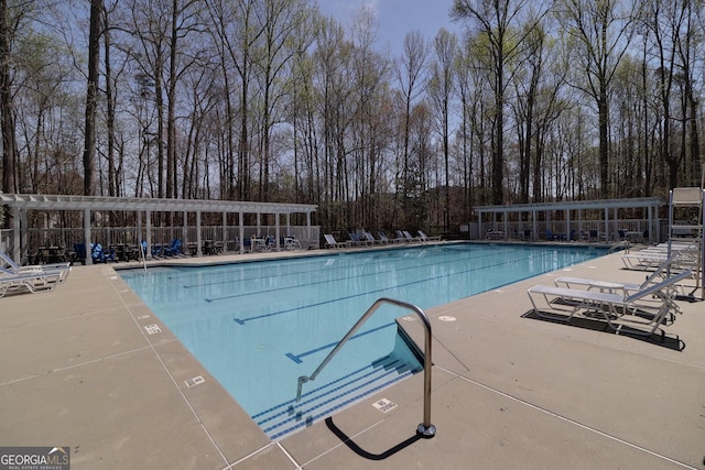 2848 Stockbridge Way, Dacula, GA 30019 - community pool featuring view of scattered trees and a patio area