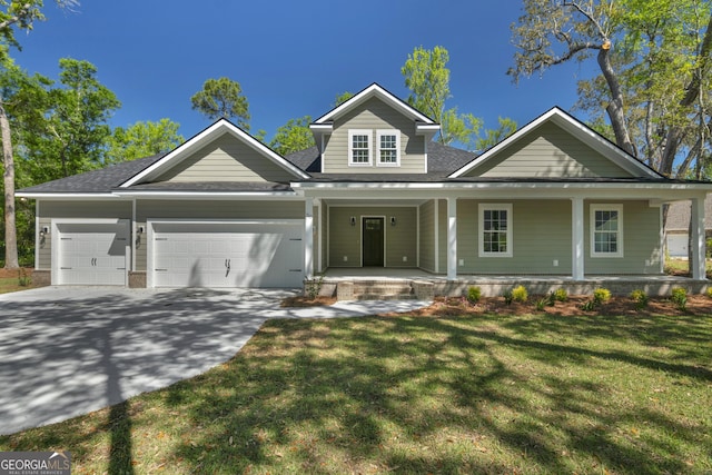 243 Barrington Oaks Dr, Brunswick, GA 31523 - view of front of home featuring an attached garage, a porch, a front yard, and concrete driveway