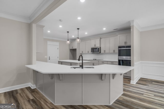 243 Barrington Oaks Dr, Brunswick, GA 31523 - kitchen with recessed lighting, dark wood finished floors, a sink, crown molding, and appliances with stainless steel finishes