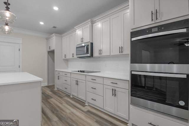 243 Barrington Oaks Dr, Brunswick, GA 31523 - kitchen featuring stainless steel appliances, recessed lighting, pendant lighting, light countertops, and ornamental molding