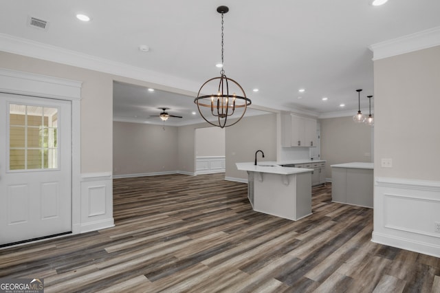 243 Barrington Oaks Dr, Brunswick, GA 31523 - kitchen featuring recessed lighting, light countertops, ornamental molding, a sink, and a kitchen bar