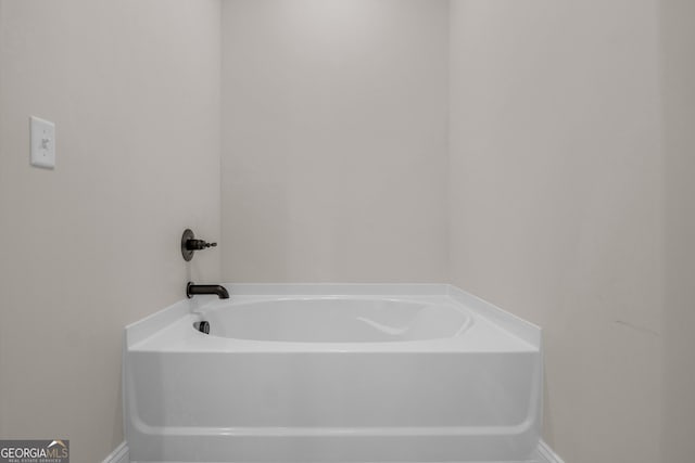 243 Barrington Oaks Dr, Brunswick, GA 31523 - bathroom featuring a garden tub and baseboards