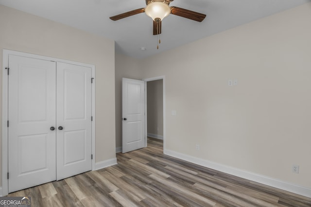 243 Barrington Oaks Dr, Brunswick, GA 31523 - unfurnished bedroom with wood finished floors, a closet, a ceiling fan, and baseboards
