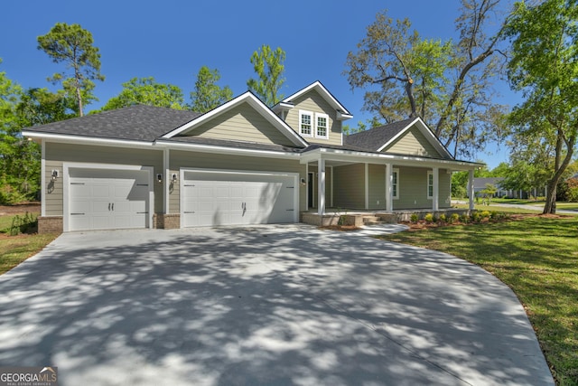 243 Barrington Oaks Dr, Brunswick, GA 31523 - craftsman-style house with concrete driveway, covered porch, an attached garage, a shingled roof, and a front yard