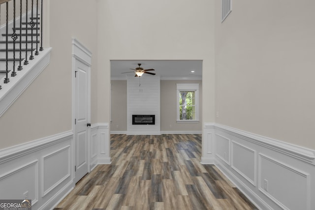 243 Barrington Oaks Dr, Brunswick, GA 31523 - corridor featuring wood finished floors, stairs, wainscoting, a high ceiling, and visible vents
