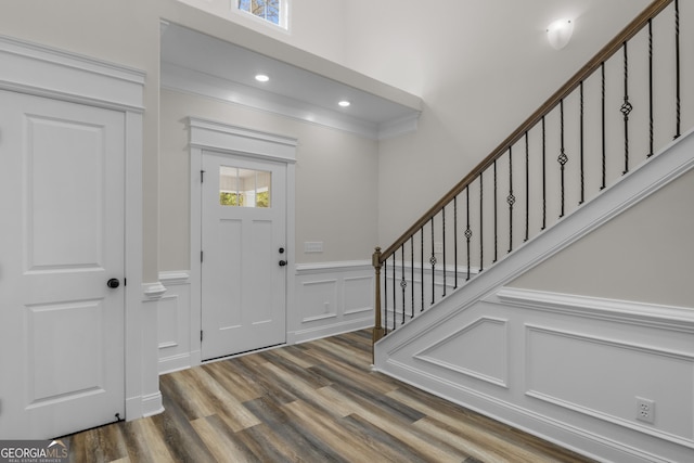 243 Barrington Oaks Dr, Brunswick, GA 31523 - entrance foyer with stairway, a decorative wall, wood finished floors, a wainscoted wall, and recessed lighting