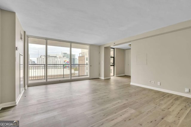 620 Peachtree St NE Unit 1413, Atlanta, GA 30308 - interior space with baseboards, floor to ceiling windows, wood finished floors, and a view of city