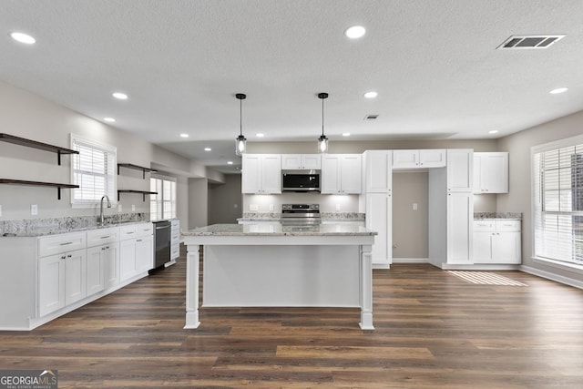 kitchen featuring dark wood finished floors, white cabinets, appliances with stainless steel finishes, and open shelves