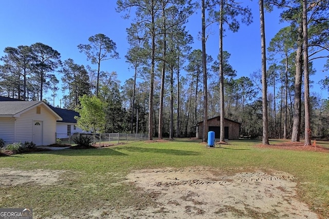 view of yard with an outbuilding, fence, and a garage