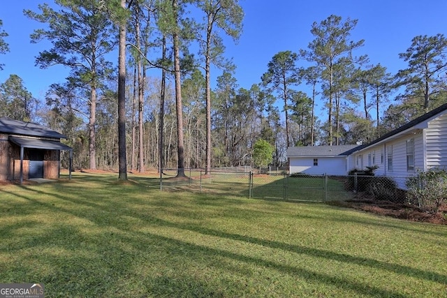 view of yard featuring an outdoor structure and fence