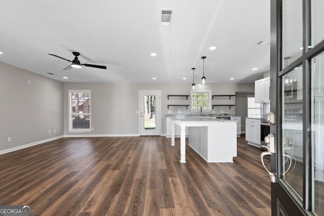kitchen with a kitchen breakfast bar, white cabinets, dark wood-type flooring, and open shelves