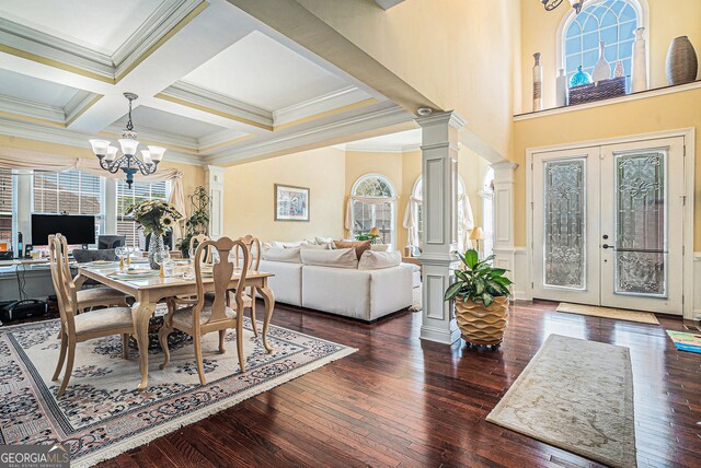 dining area with crown molding, hardwood / wood-style floors, an inviting chandelier, beamed ceiling, and coffered ceiling