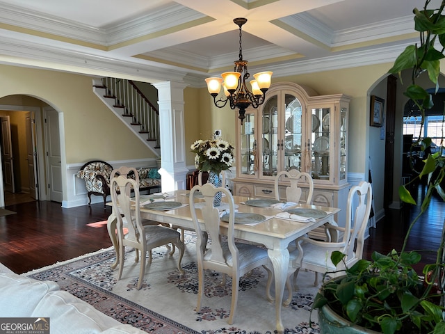 dining area with arched walkways, ornamental molding, wood finished floors, and an inviting chandelier