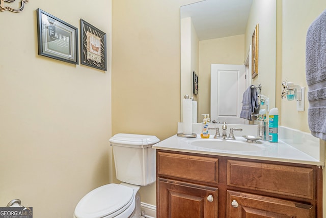 half bath with vanity and toilet