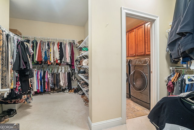 walk in closet featuring washer / dryer and carpet