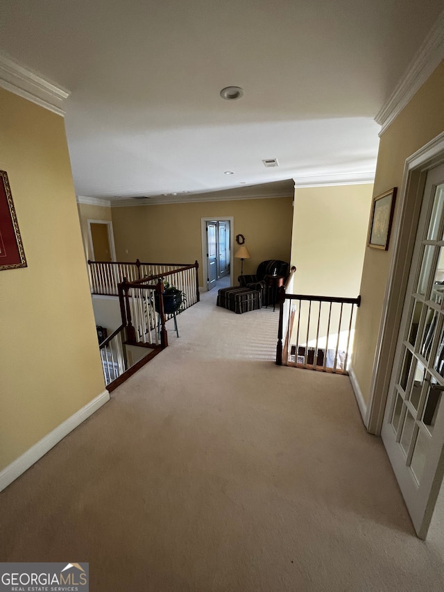 corridor with carpet, an upstairs landing, and crown molding