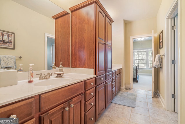 bathroom featuring tile patterned floors, baseboards, and vanity
