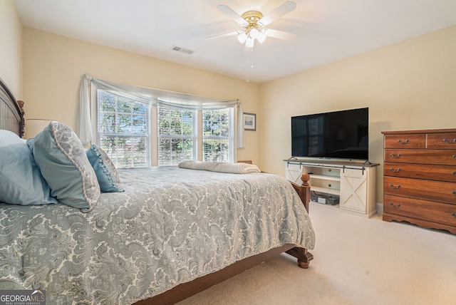 bedroom with a ceiling fan, visible vents, and carpet flooring
