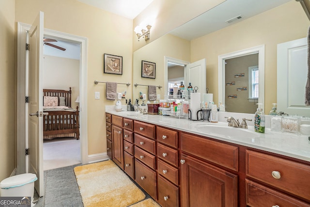 ensuite bathroom with a sink, double vanity, visible vents, a ceiling fan, and ensuite bath