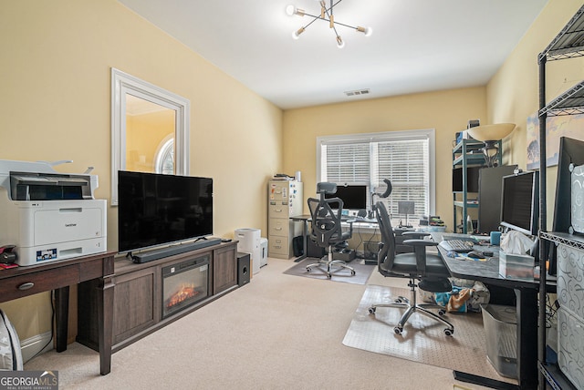 carpeted home office with visible vents and an inviting chandelier