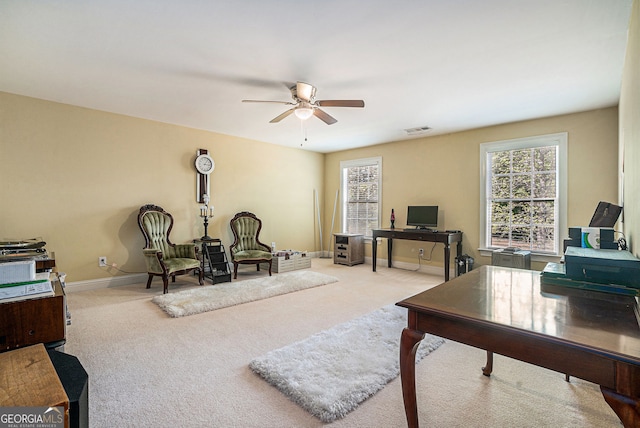 office featuring ceiling fan, baseboards, carpet flooring, and visible vents