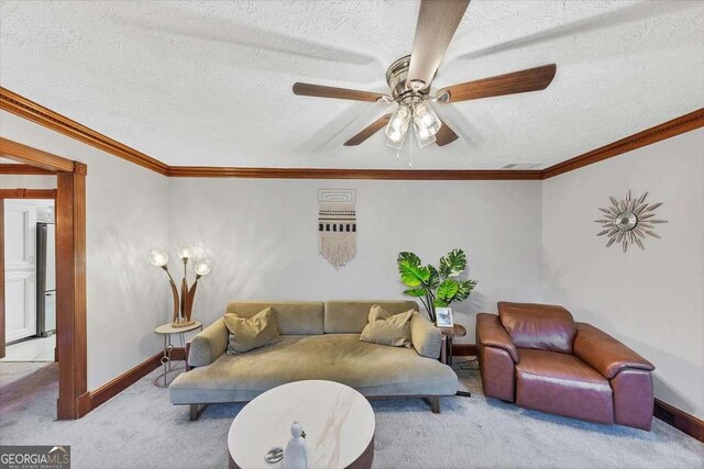 living area with ornamental molding, carpet, baseboards, and a textured ceiling