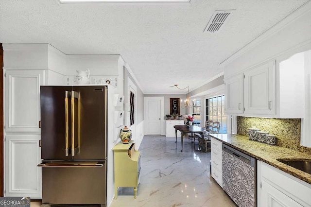 kitchen featuring visible vents, marble finish floor, stainless steel appliances, tasteful backsplash, and white cabinetry