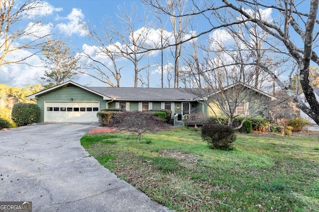 ranch-style house featuring driveway, a garage, and a front lawn